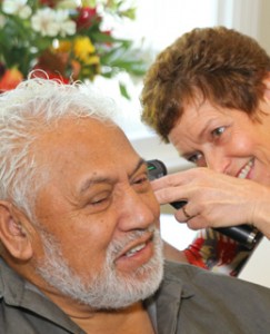 Heidi Assessing Clients Ear Canal with Otoscope